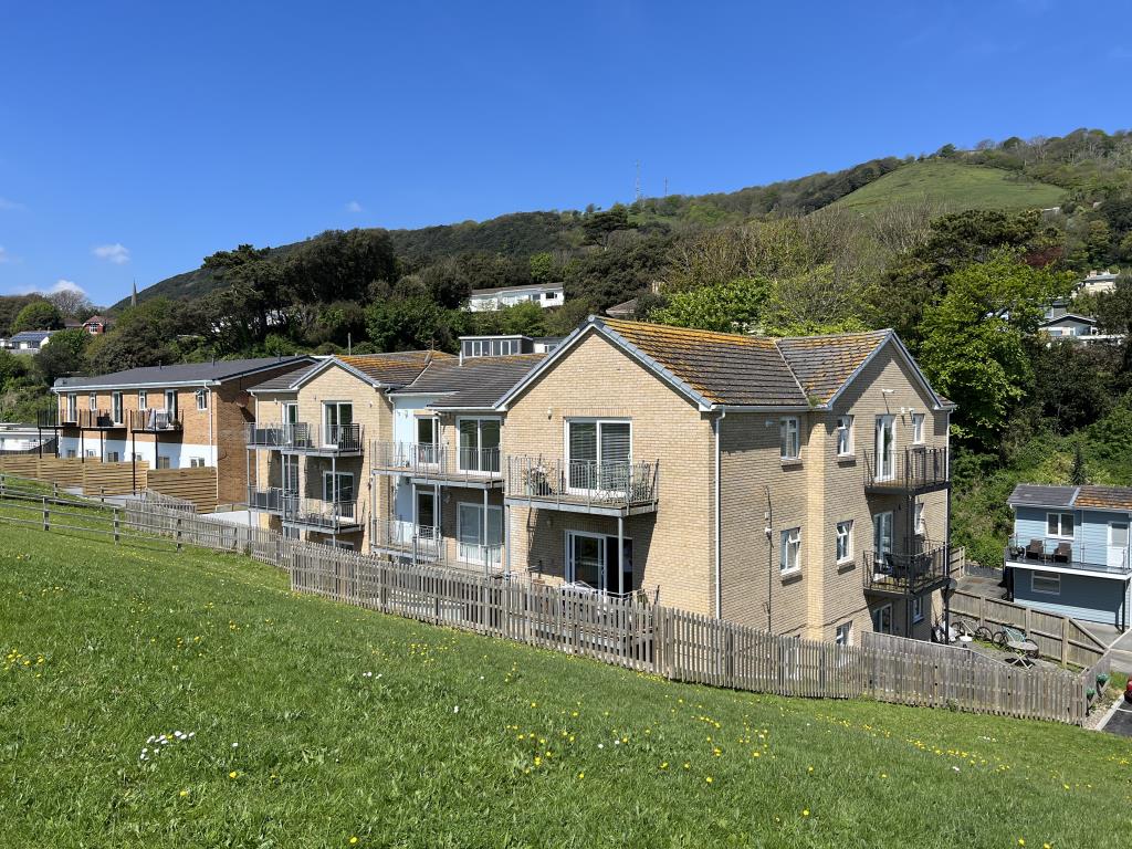 Lot: 6 - TWO-BEDROOM FLAT FOR INVESTMENT OR OCCUPATION - Block of apartments with balconys set into hillside